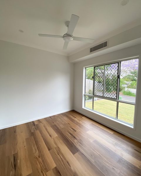 Waterproof Native Blackbutt hybrid wideboard planks featuring a rigid SPC core and authentic matte hardwood grain.
