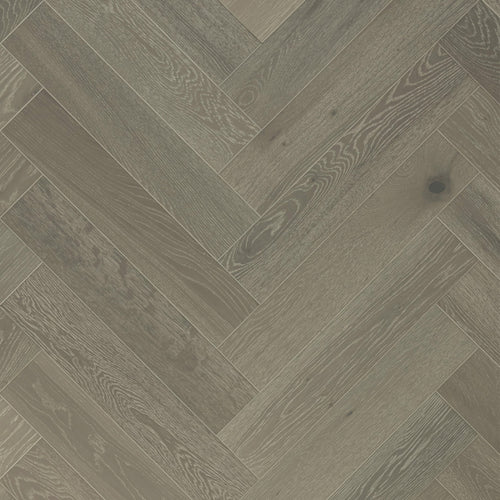 Close-up of Forest Grey timber in a herringbone pattern with cool ash tones and a smooth matte finish.