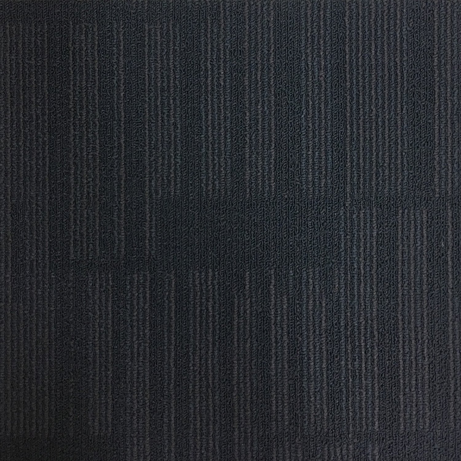 Close-up view of a black textured Pepper carpet tile sample.