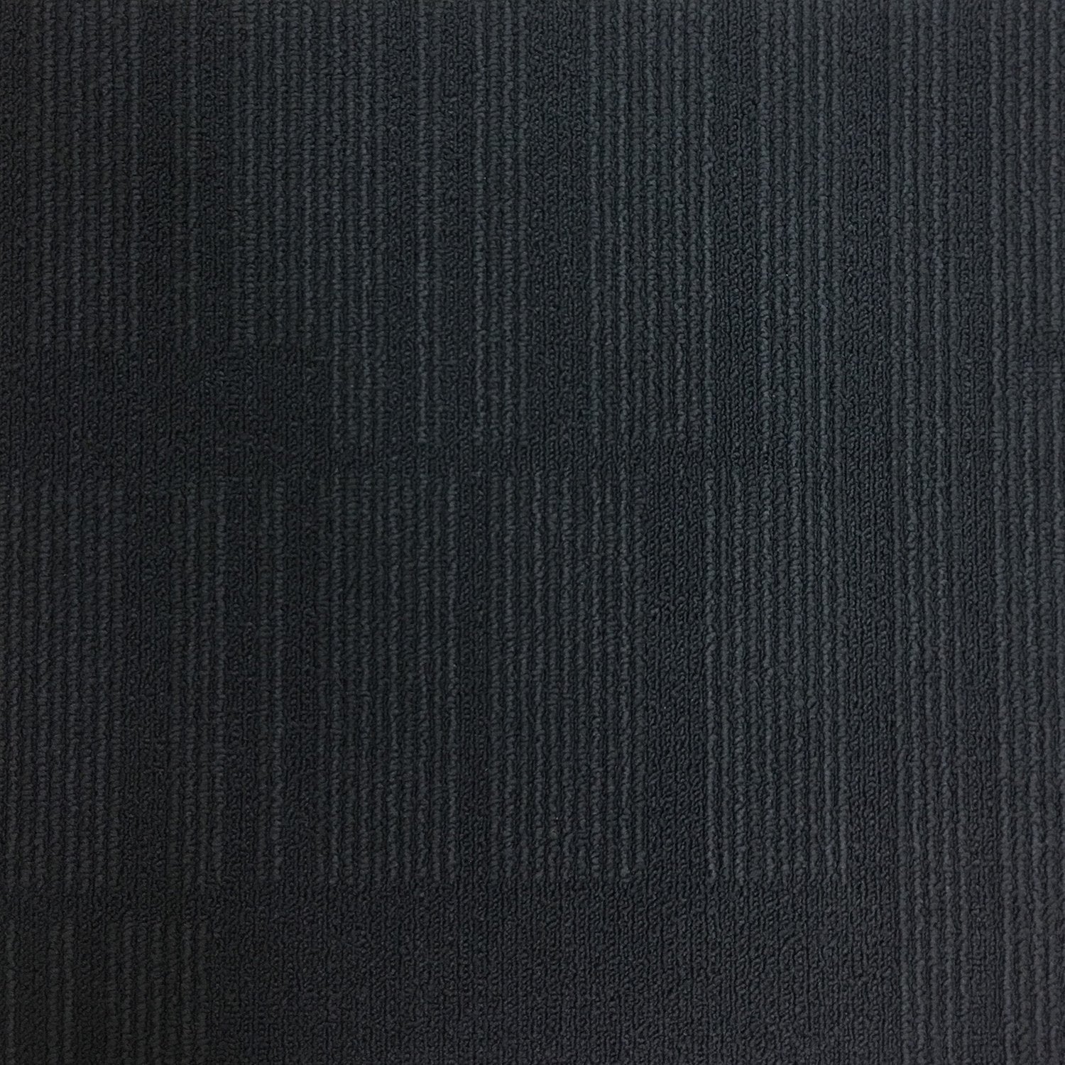 Soft charcoal and smoke grey carpet tiles with a subtle heathered texture and low-profile loop pile.