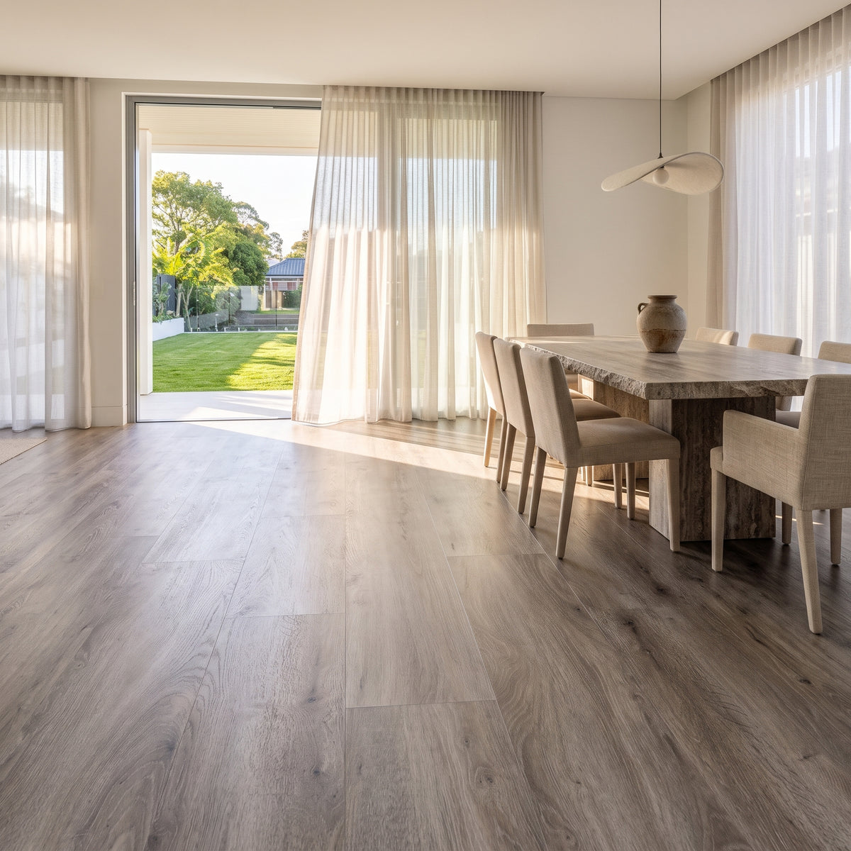 Merino Mist vinyl flooring, smooth matte. Durable waterproof luxury vinyl planks with a light, warm-grey hardwood grain.